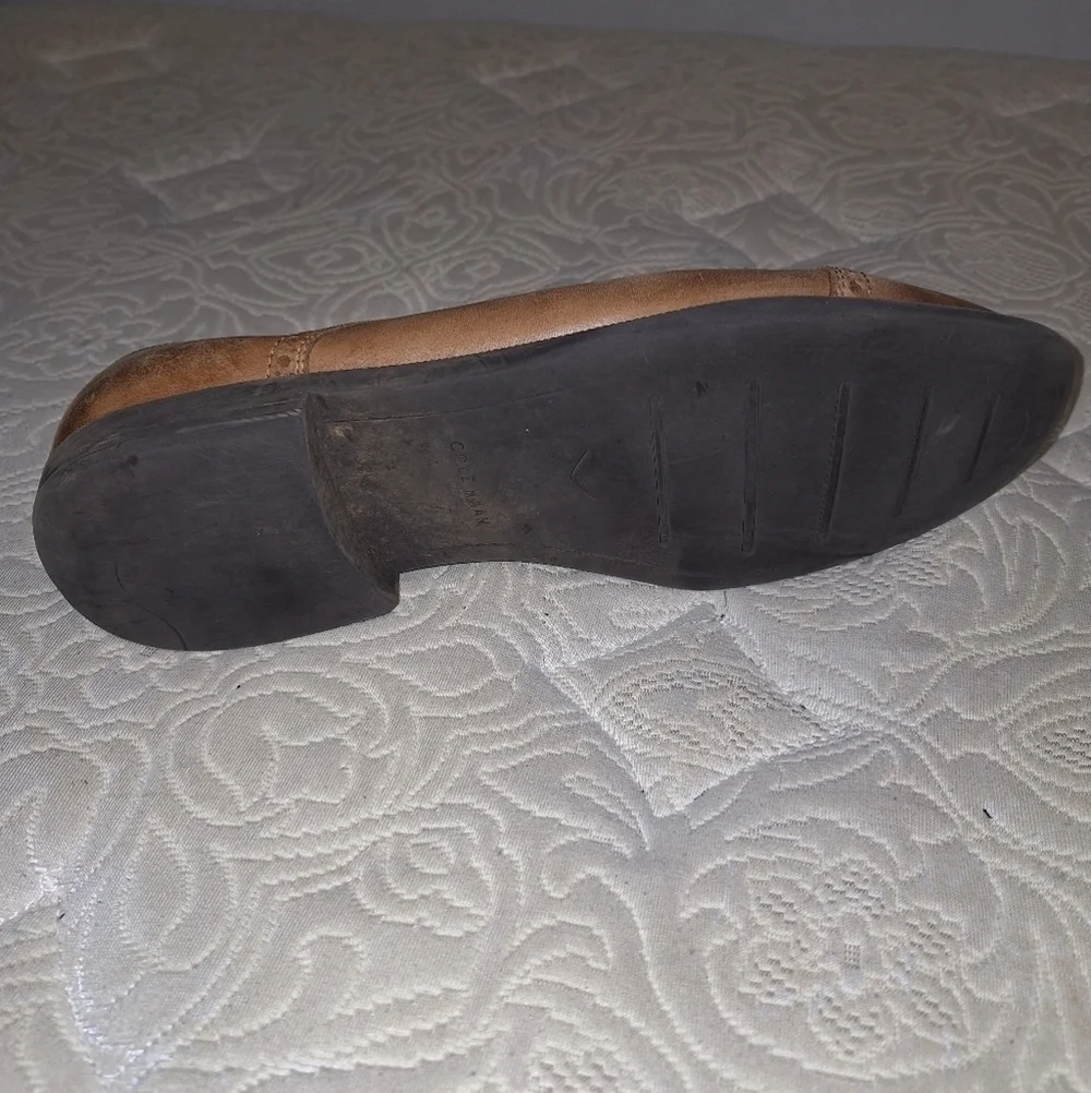 A pair of Cole Haan Oxfords in a men's size 12M. Pre-loved in good condition.